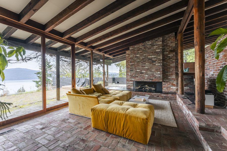 Living room with brick fireplace and water view