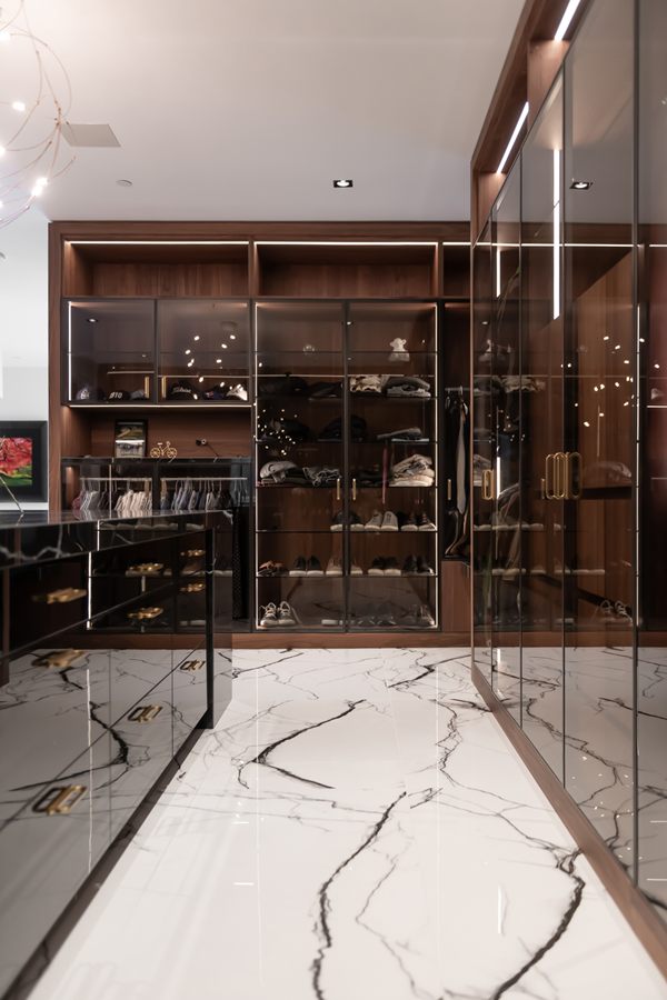 Glass-front wardrobes along the closet wall