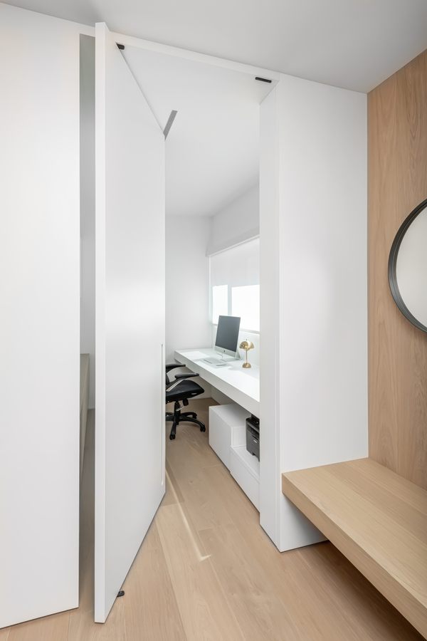 Flush hidden door opening into a home office