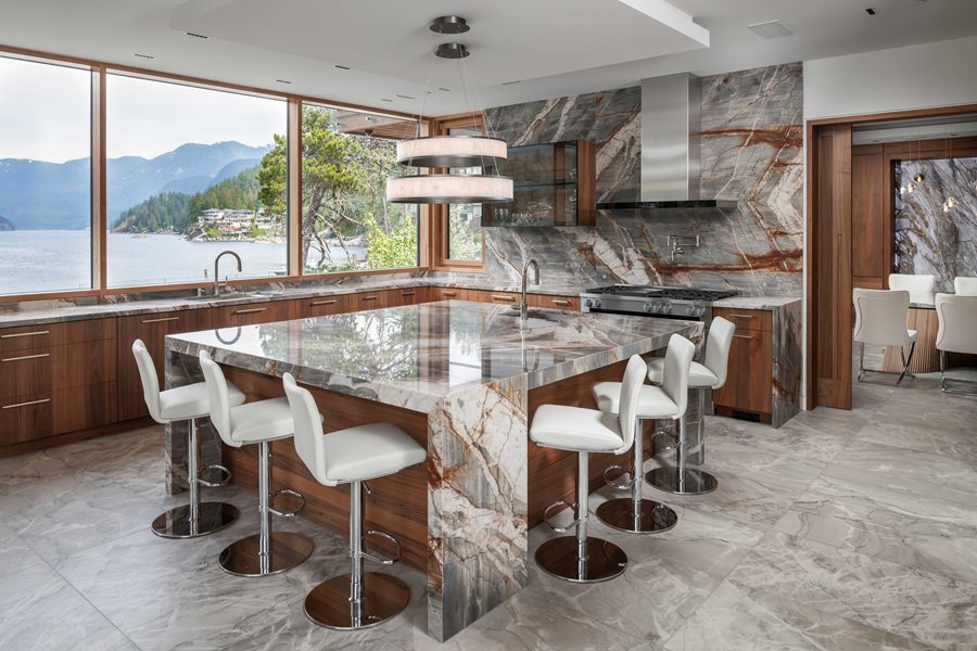 Island Residence kitchen with a marble waterfall island and ocean views