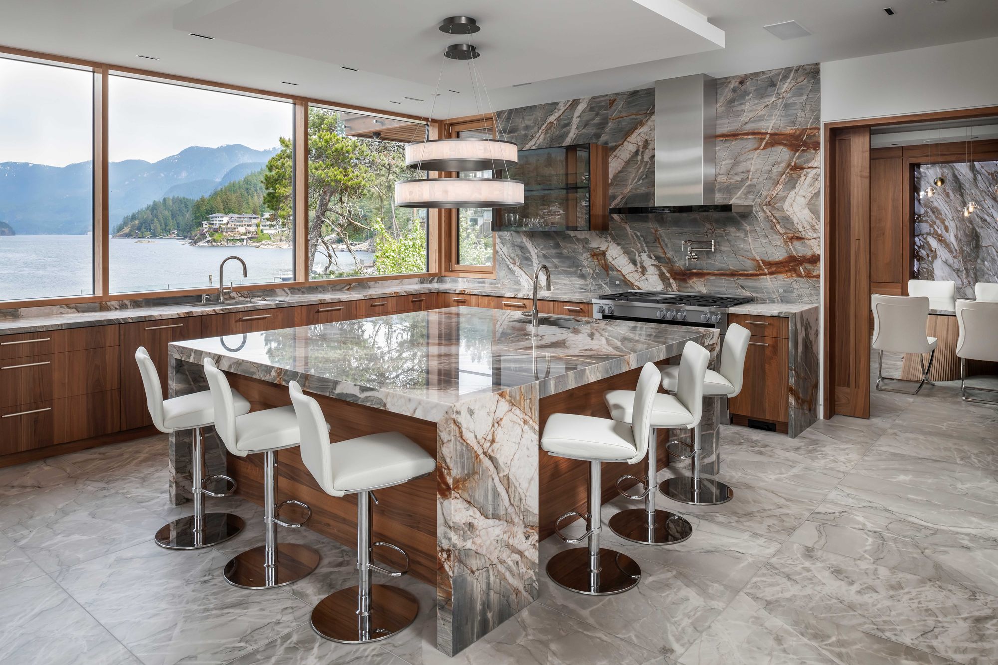 Island Residence kitchen with a marble waterfall island and ocean views
