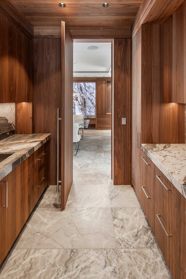 Walnut butler's pantry with marble counters