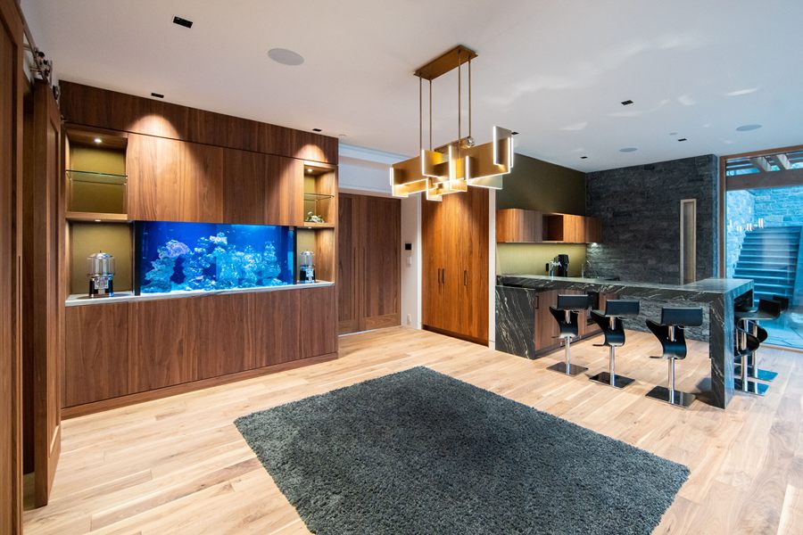 Bar and media room with built-in aquarium and walnut panelling