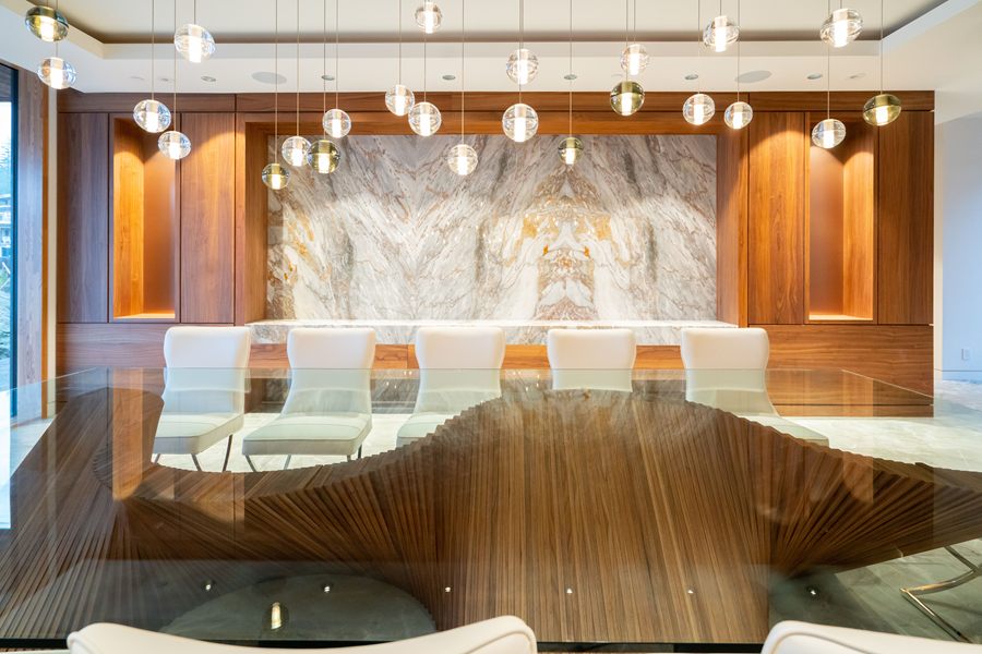 Walnut dining table and marble wall from the end of the room
