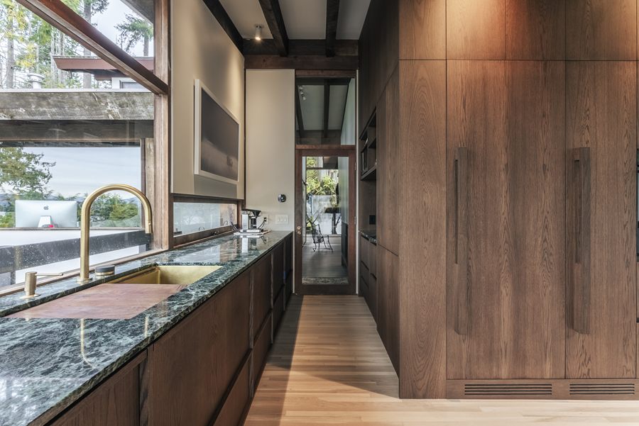 Kitchen with dark wood cabinetry and green stone counter