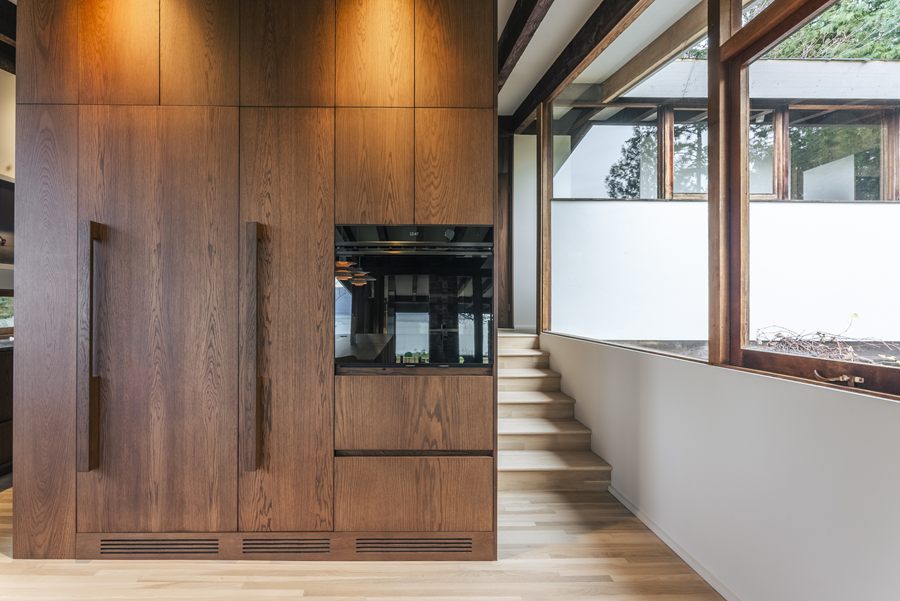 Full-height wood cabinetry with integrated ovens at Keith Residence