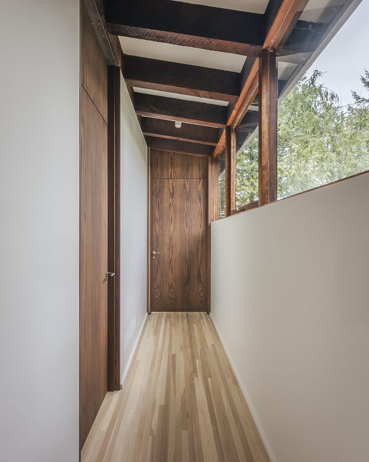 Hallway with a full-height wood door