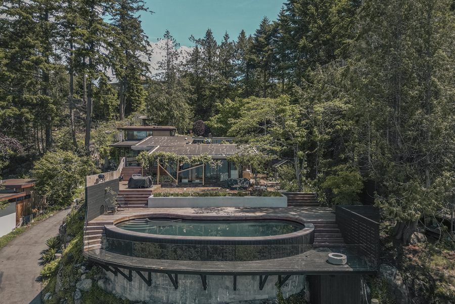Aerial view of the house and pool among the trees