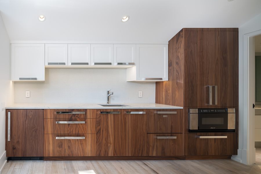 Guest kitchen with walnut lower cabinets and white uppers