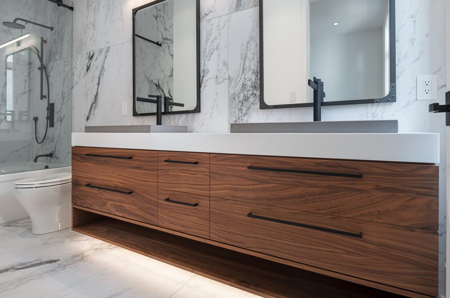 Floating walnut double vanity with under-cabinet lighting