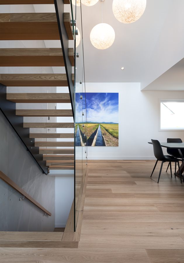 Floating staircase with oak treads and glass railing