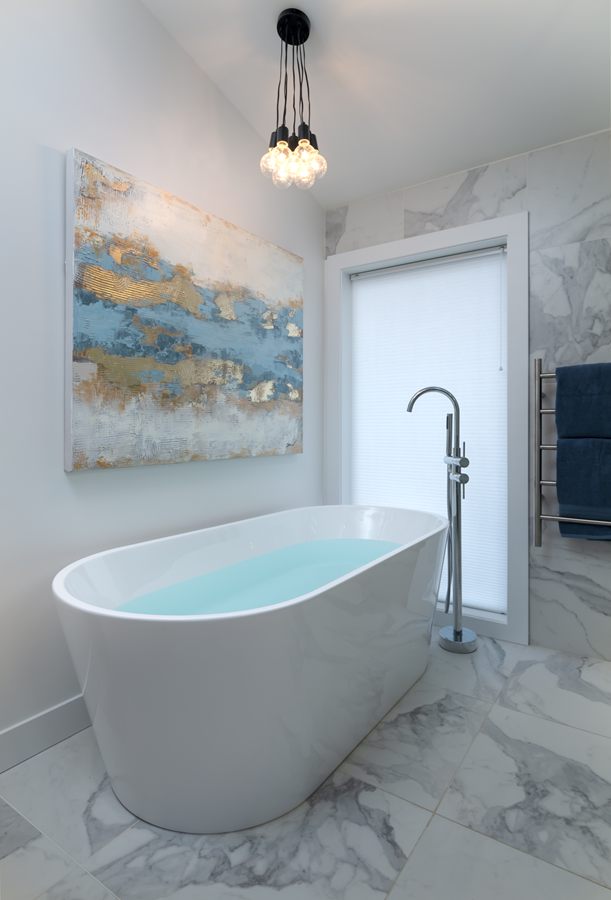 Freestanding tub in a marble-clad ensuite