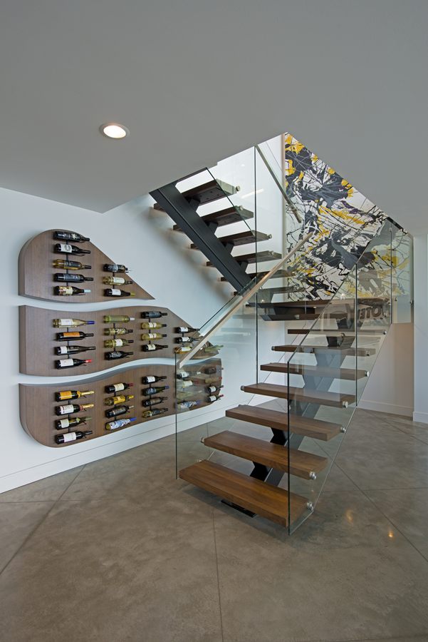 Floating stairs beside a built-in wine wall