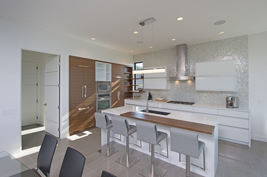 Kitchen with walnut tall cabinets and a white island