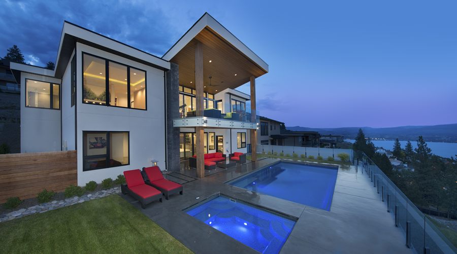 Rear of the house at dusk with pool and lake view