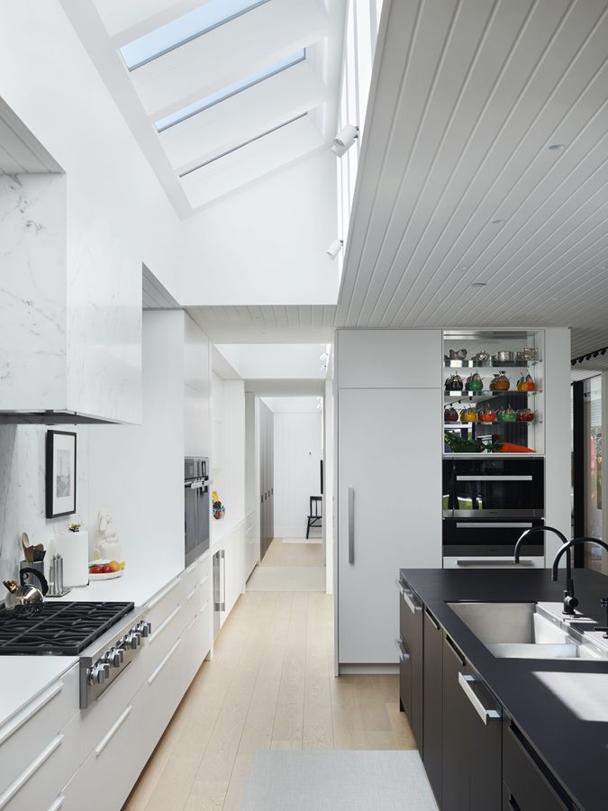 Galley kitchen under a row of skylights