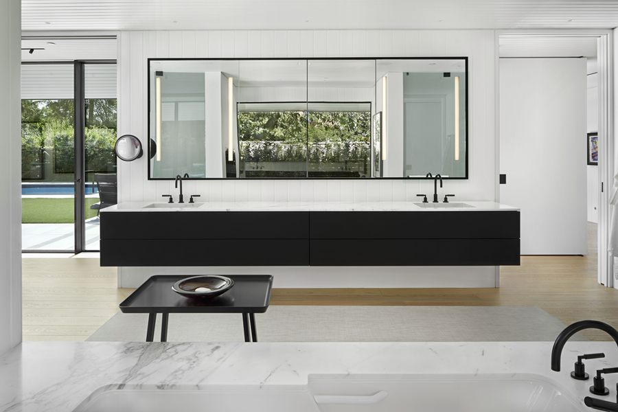 Ensuite with a floating black double vanity