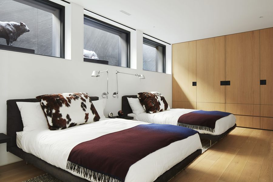 Guest bedroom with oak wardrobe wall