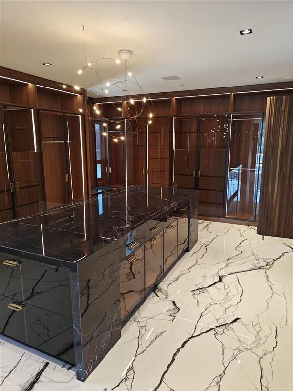 Dressing room island and glass-front wardrobes during installation